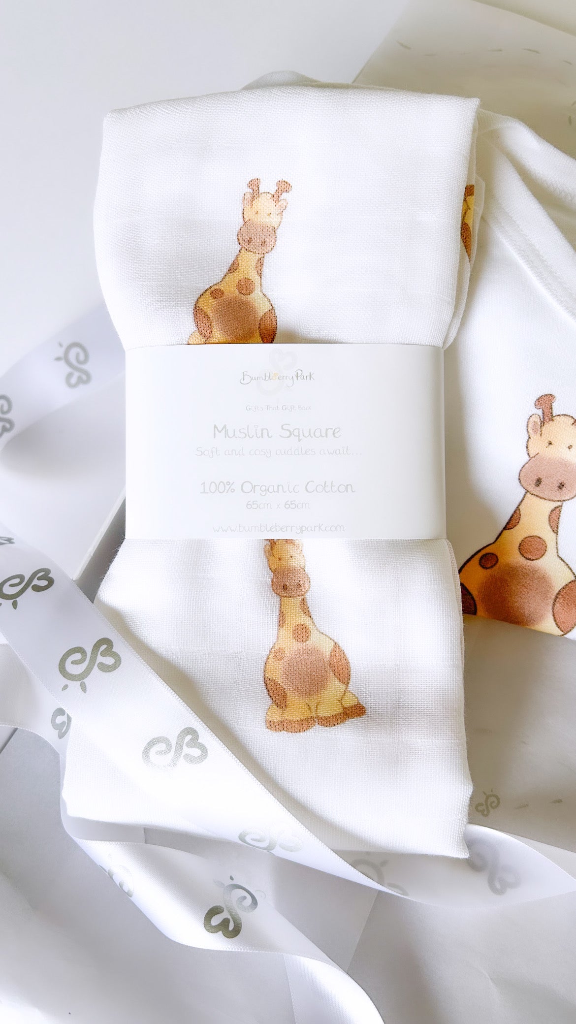 organic soft white baby muslin square with cute safari giraffe print pattern 