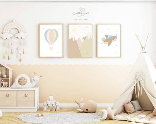 set of three matching little explorer nursery posters for children's bedroom. Neutral nursery decor prints with travel and transport theme decor with mountains, sunshine, hot air balloon and aeroplane features