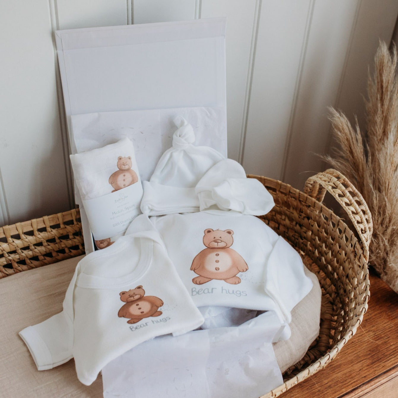woodland bear organic cotton new baby clothing gift set with luxury gift hamper placed inside a moses basket