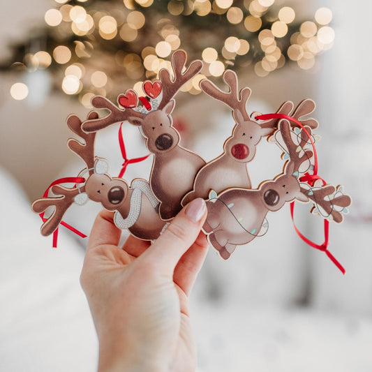 a collection of four wooden reindeer hanging christmas decorations 