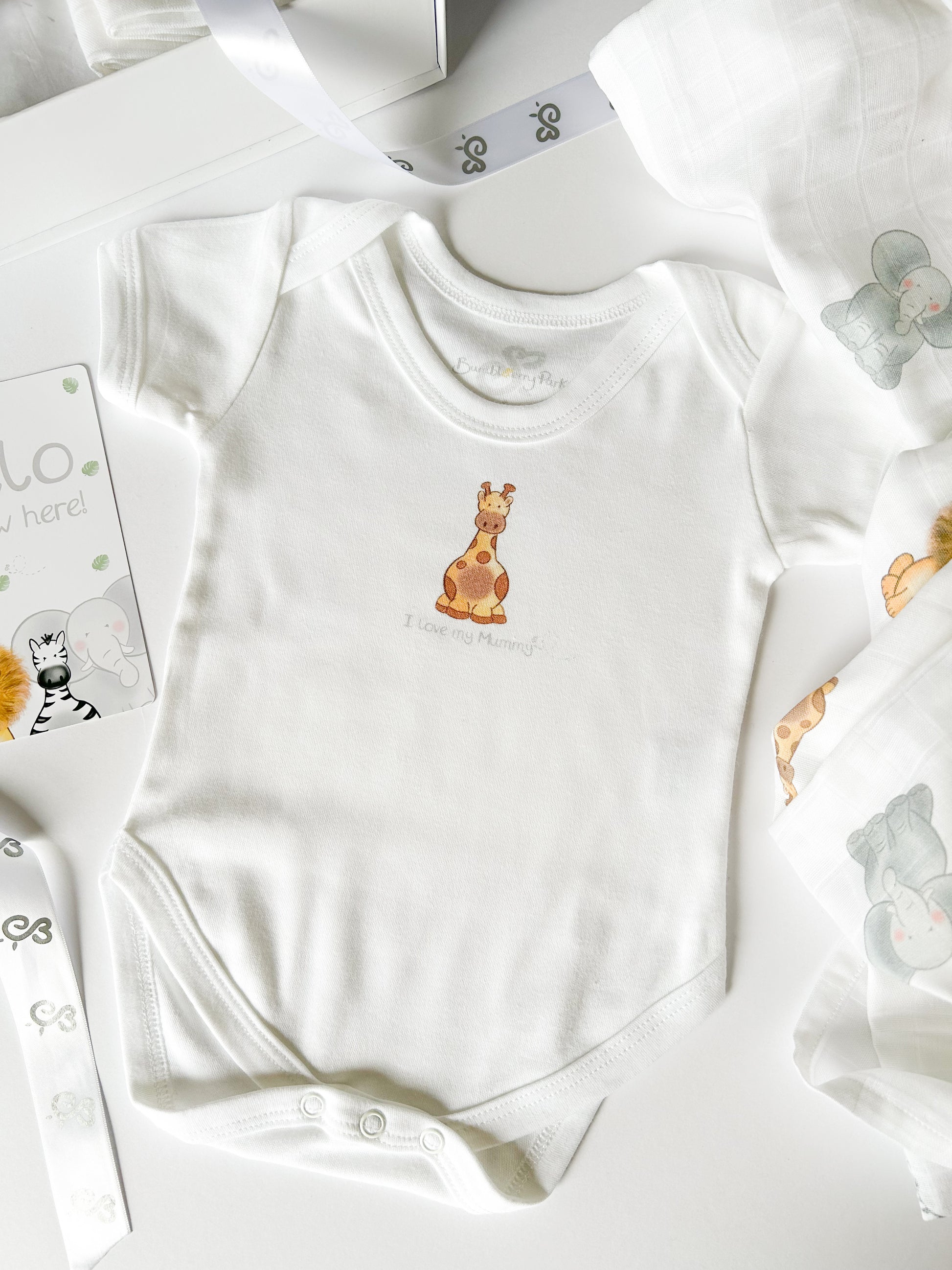 new baby gift hamper with personalised vest, baby milestone cards and muslin swaddle