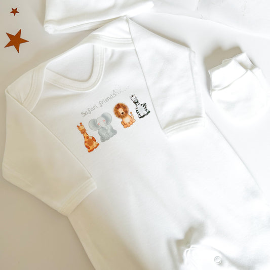 soft white baby sleepsuit printed with a muted safari animal print design