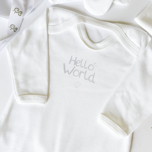 white soft newborn baby sleepsuit with hello world printed on the front in grey text with a love heart