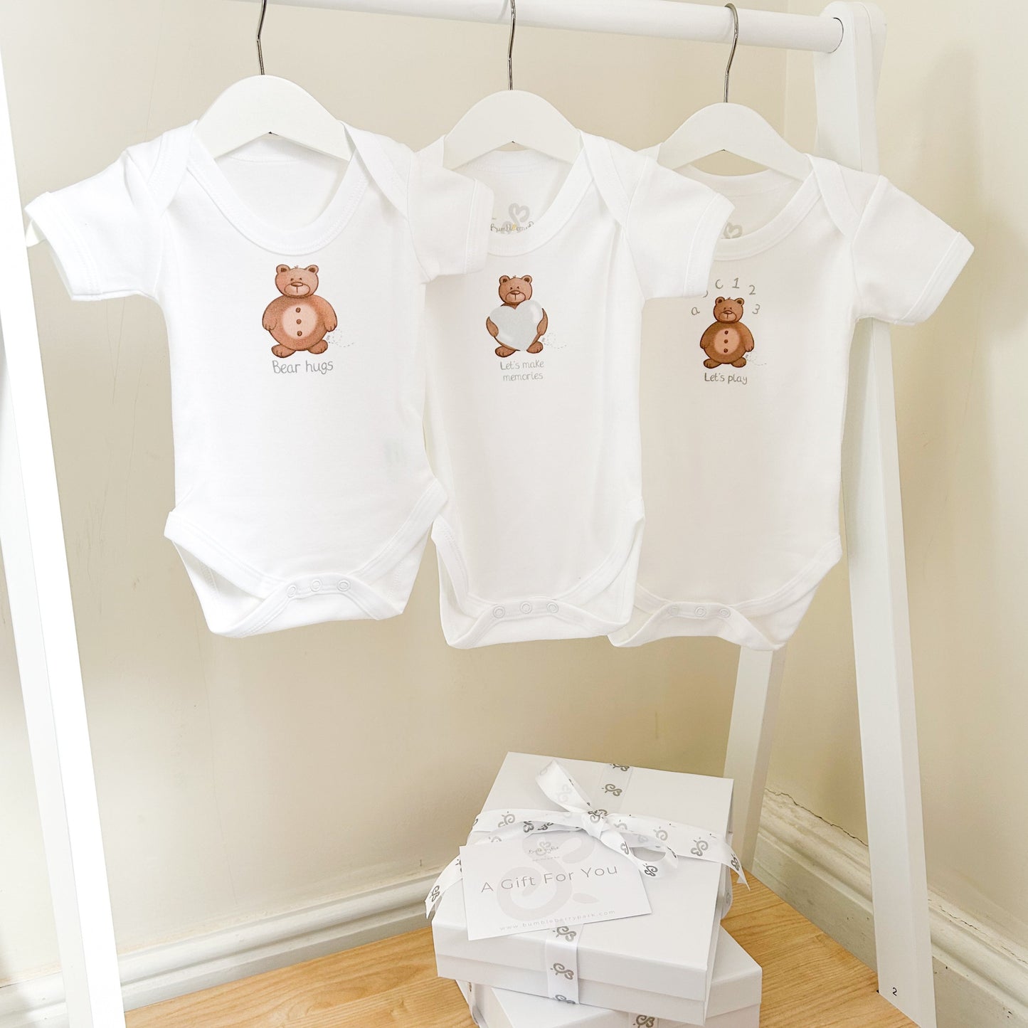 set of 3 baby bodysuits with teddy bear designs and "bear hugs" "let's make memories" and "Let's Play" inspirational quotes