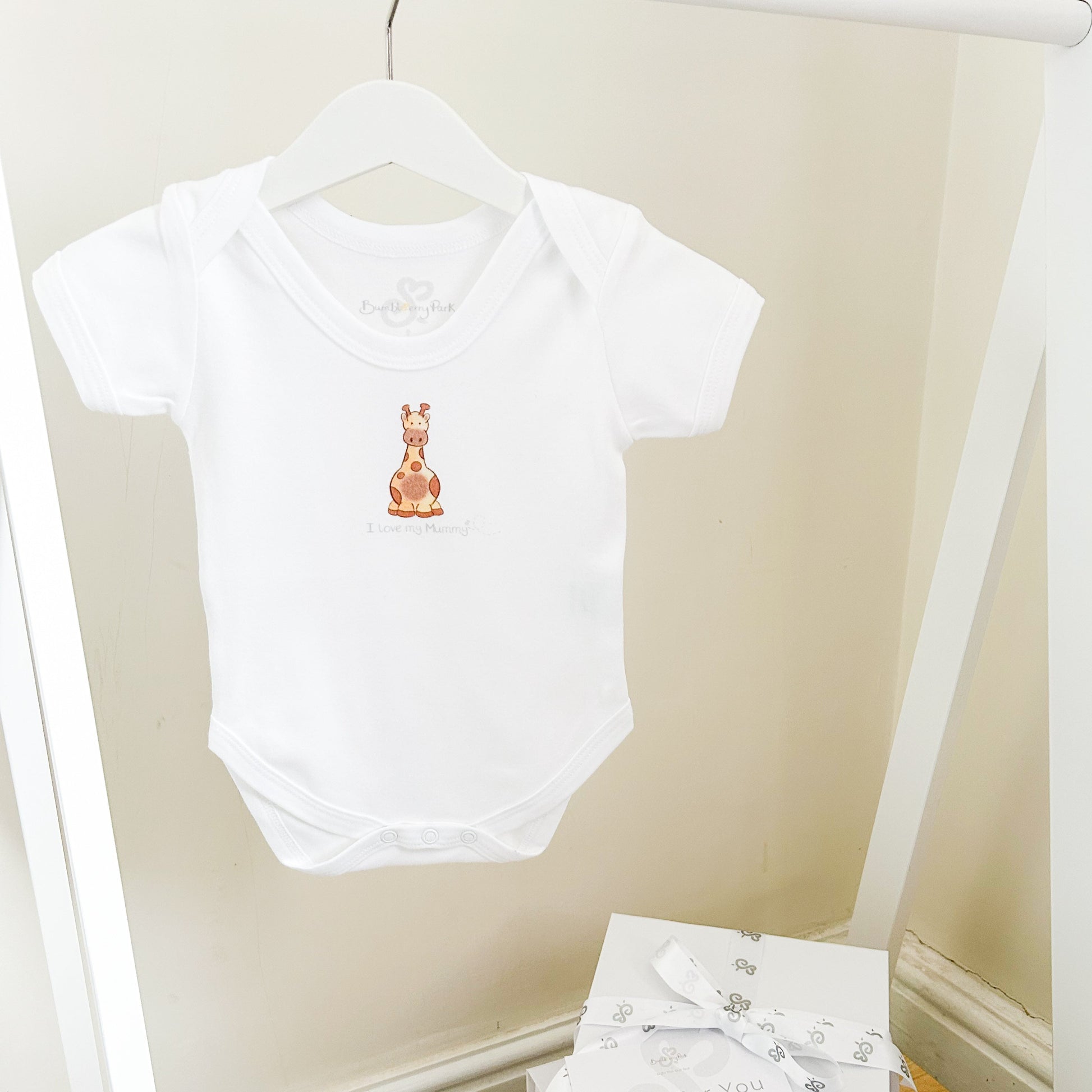 white baby bodysuit with safari giraffe design and I love my mummy print with a luxury white gift box and ribbon