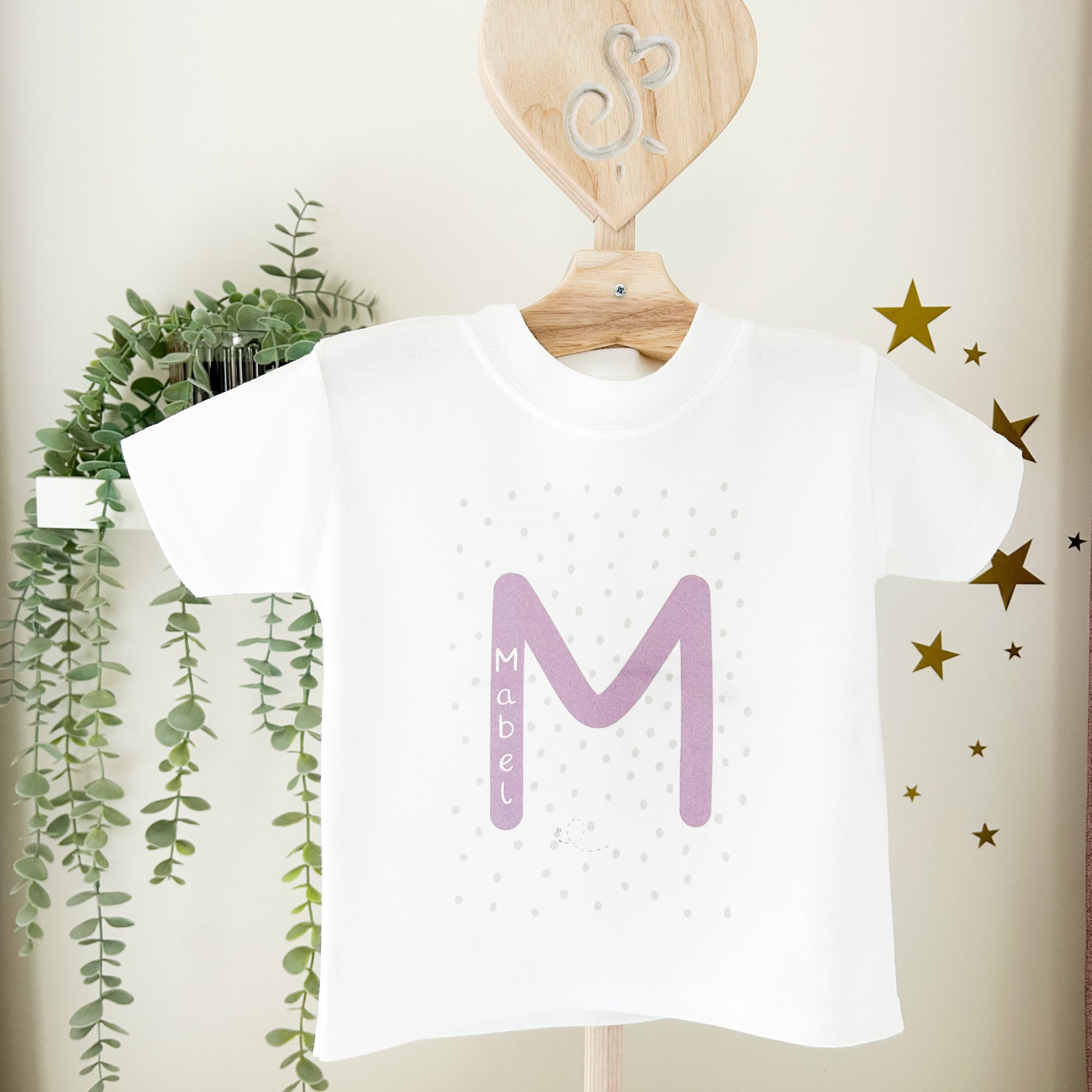 white children's t-shirt with spotty and dotty background and initial print with name 