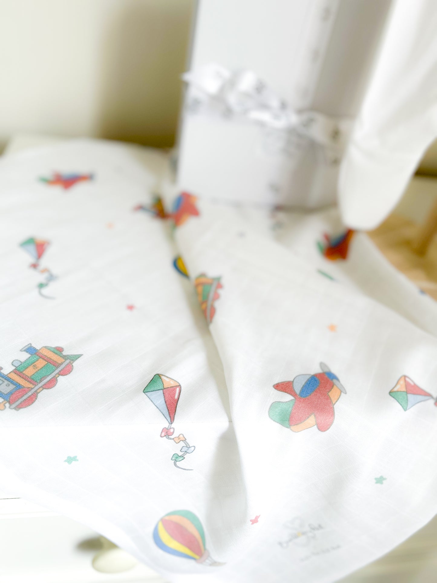 close up of a travel and transport printed muslin for new baby gift