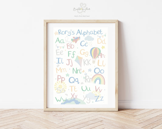 alphabet nursery print in pastel colours with little explorer theme with aeroplanes, clouds, hot air balloons kits and rainbows