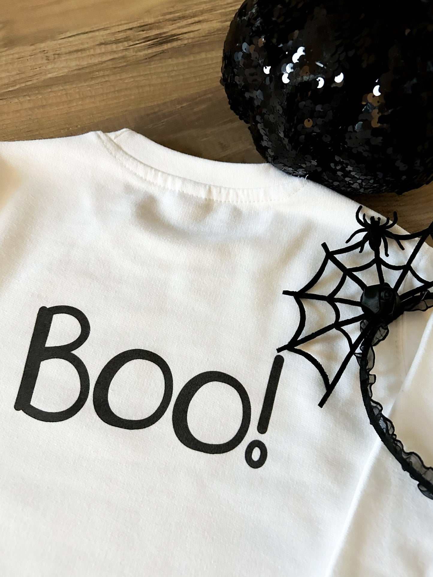 back of white children's Halloween sweatshirt with large Boo! text print