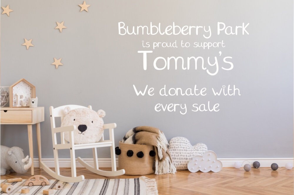  nursery decor with woodland toys and text describing charity donation