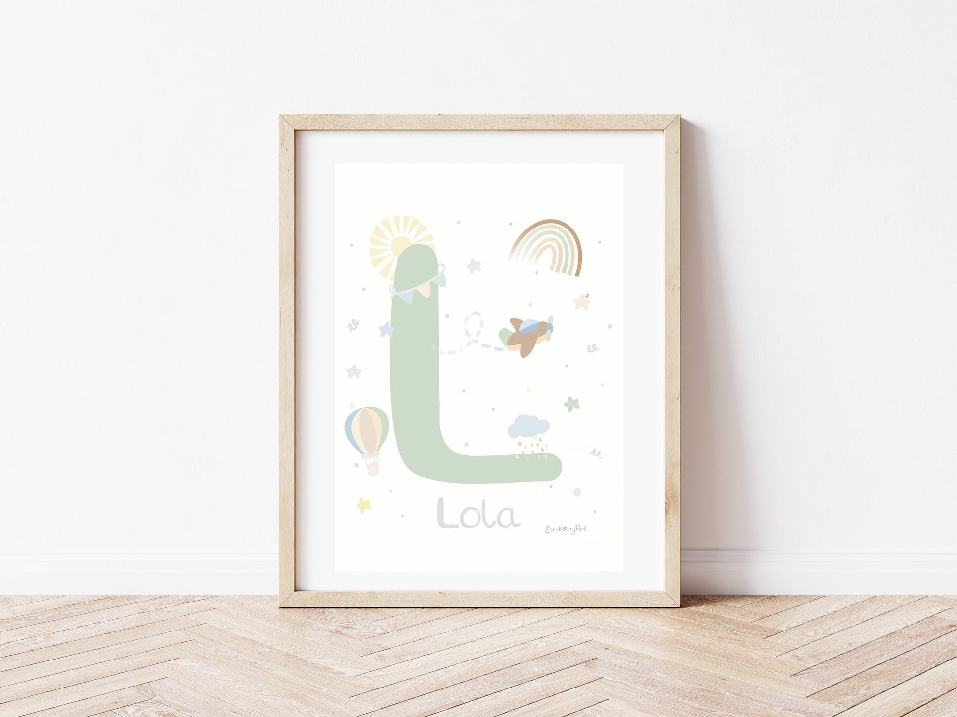 nursery print of baby name and letter in neutral tones with rainbows, sunshine, hot air balloon and stars