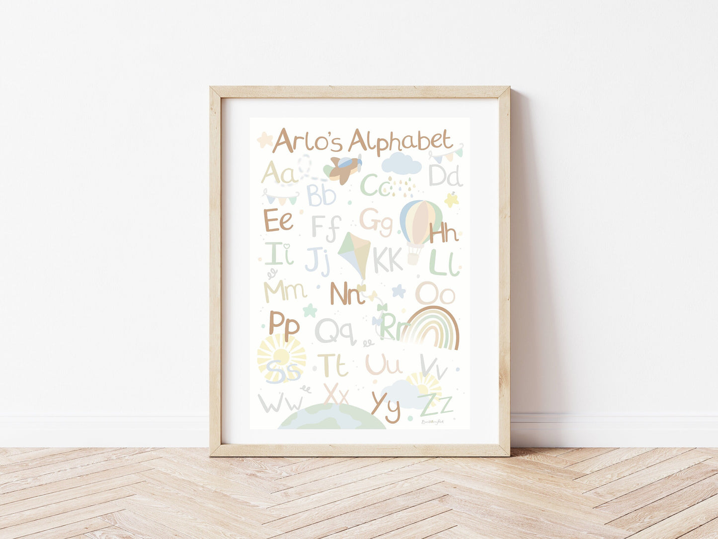 alphabet nursery print in neutral colours with little explorer theme with aeroplanes, clouds, hot air balloons kits and rainbows in a playroom
