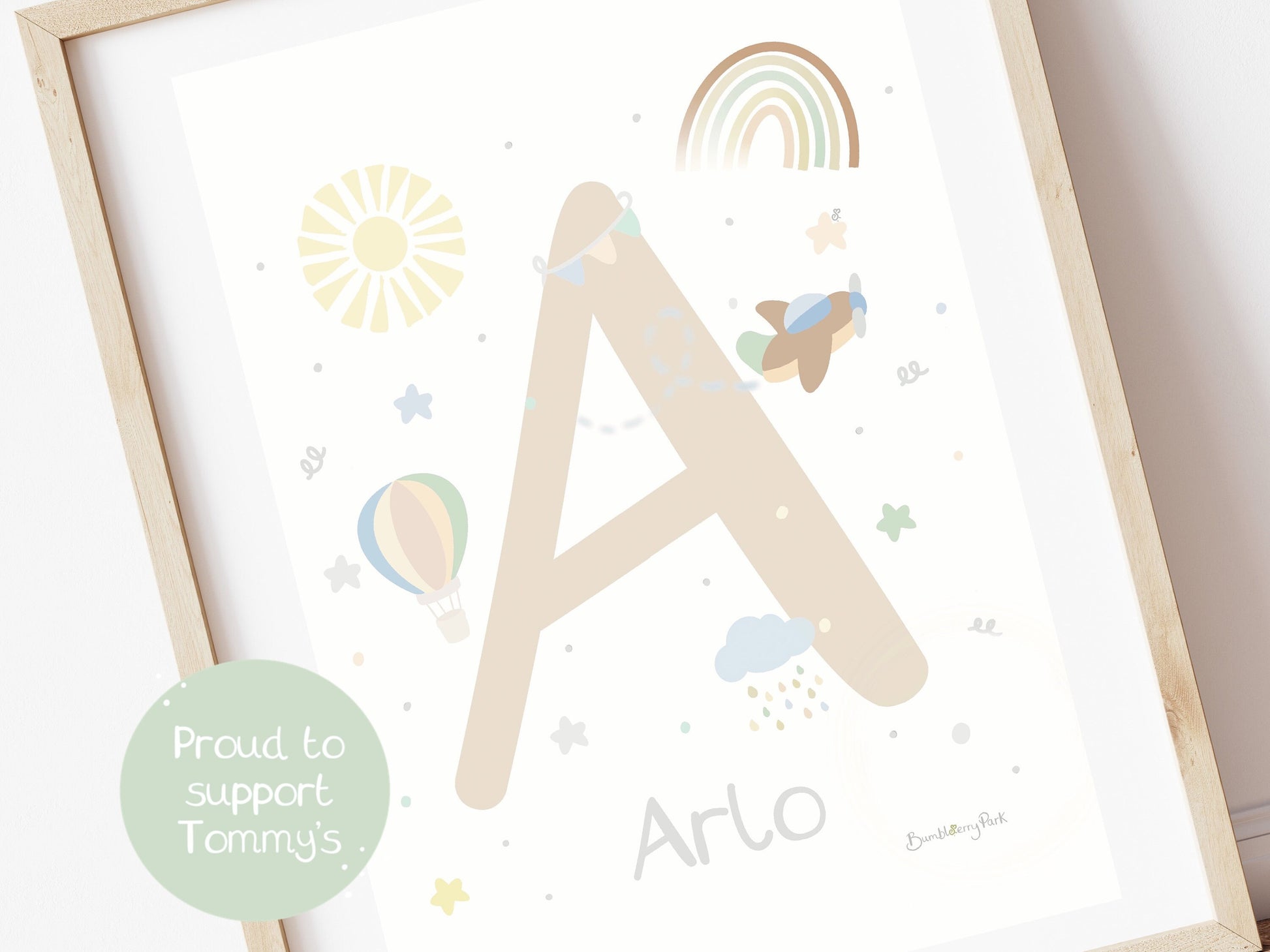 close up of an initial and name print for a boho nursery with rainbows and aeroplanes
