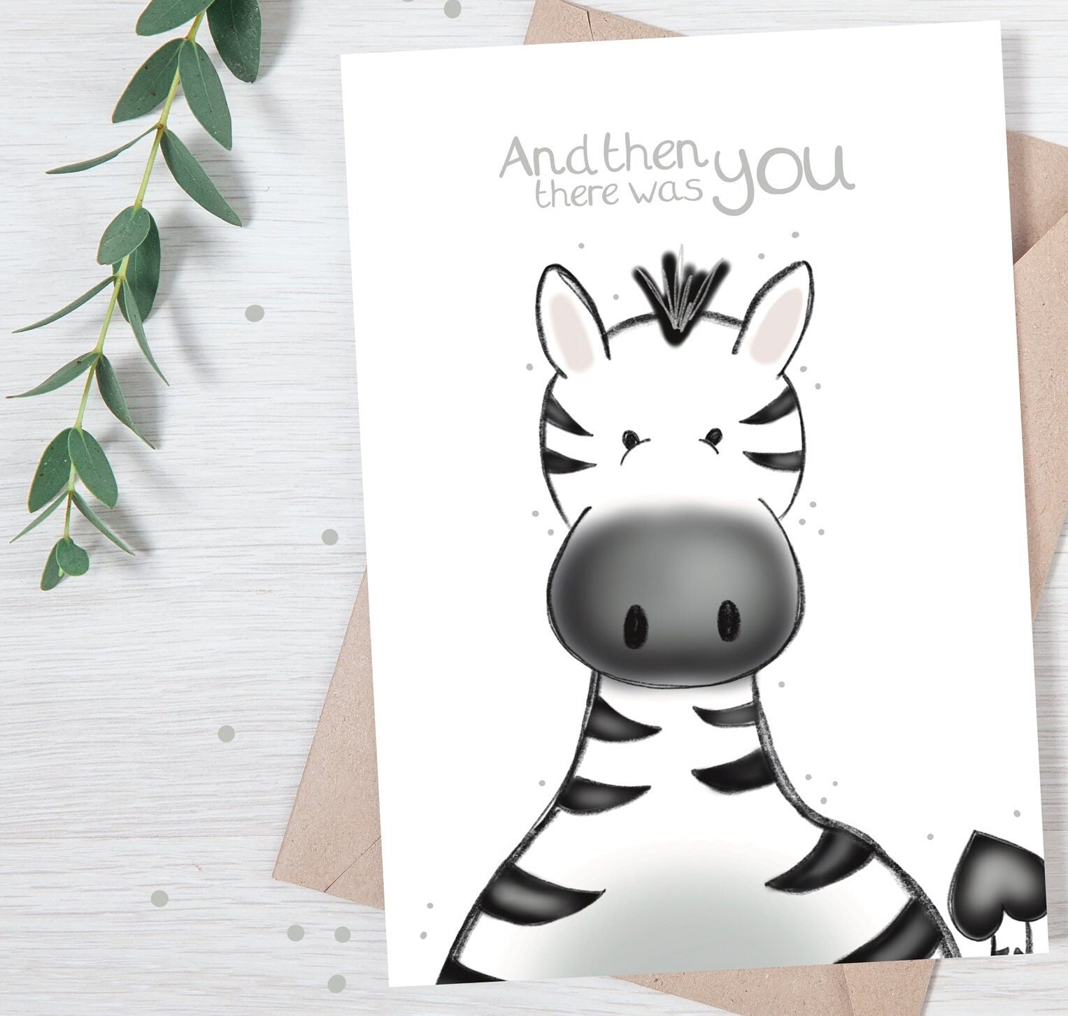 luxury new baby baby shower greetings card with a safari theme baby zebra popping up from the bottom with the title &quote "and then there was you" on a white background, with a kraft envelope