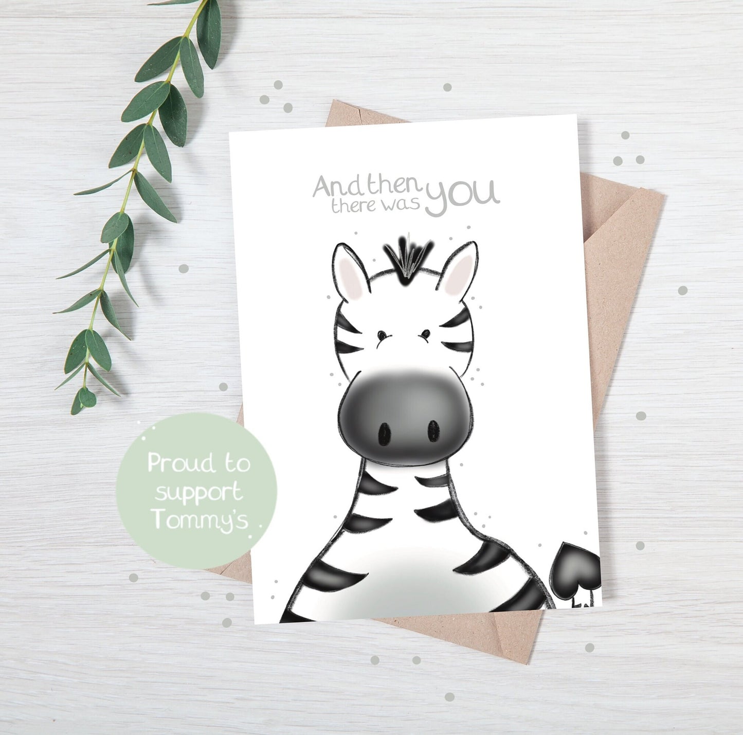 luxury new baby christening greetings card with a safari theme baby zebra popping up from the bottom with the title &quote "and then there was you" on a white background, with a kraft envelope